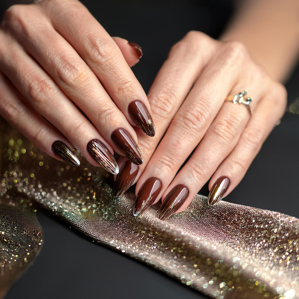 Long chocolate-brown nails with a mirrored chrome finish