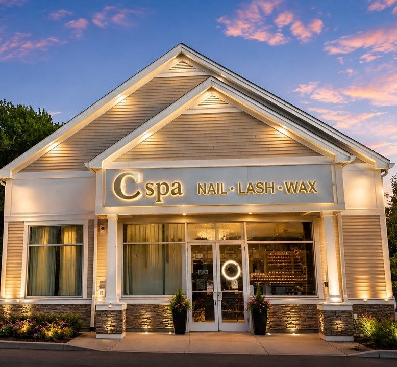 The C Spa storefront on Eastern Ave at dusk, the C spa Nail · Lash · Wax sign lit above the glass doors