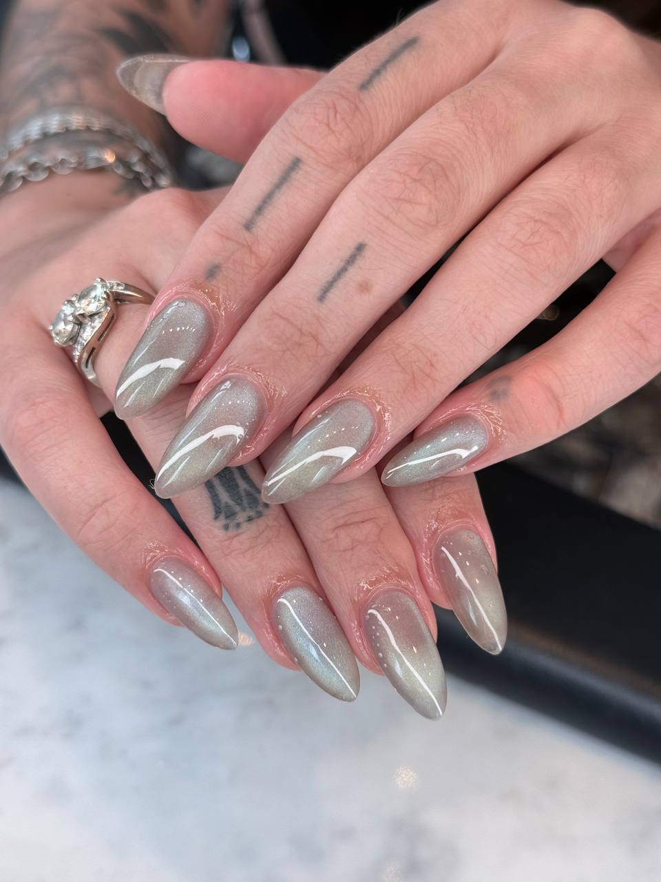 Sage cat-eye almond nails with a velvet shimmer