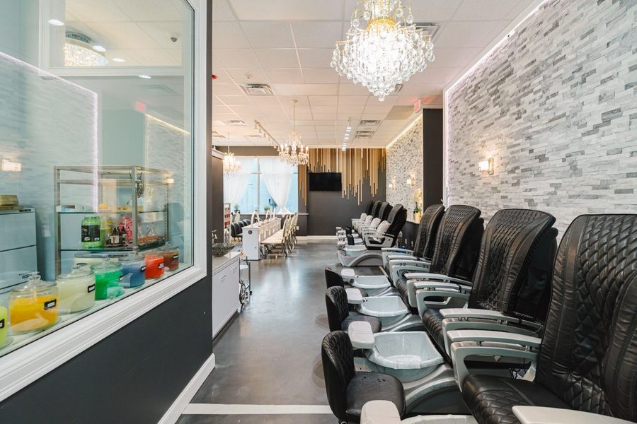 Pedicure chairs lined along the stone feature wall