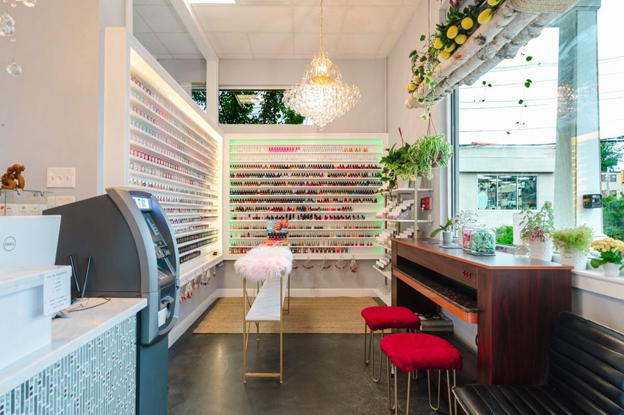 The polish wall — hundreds of colours backlit above the front counter